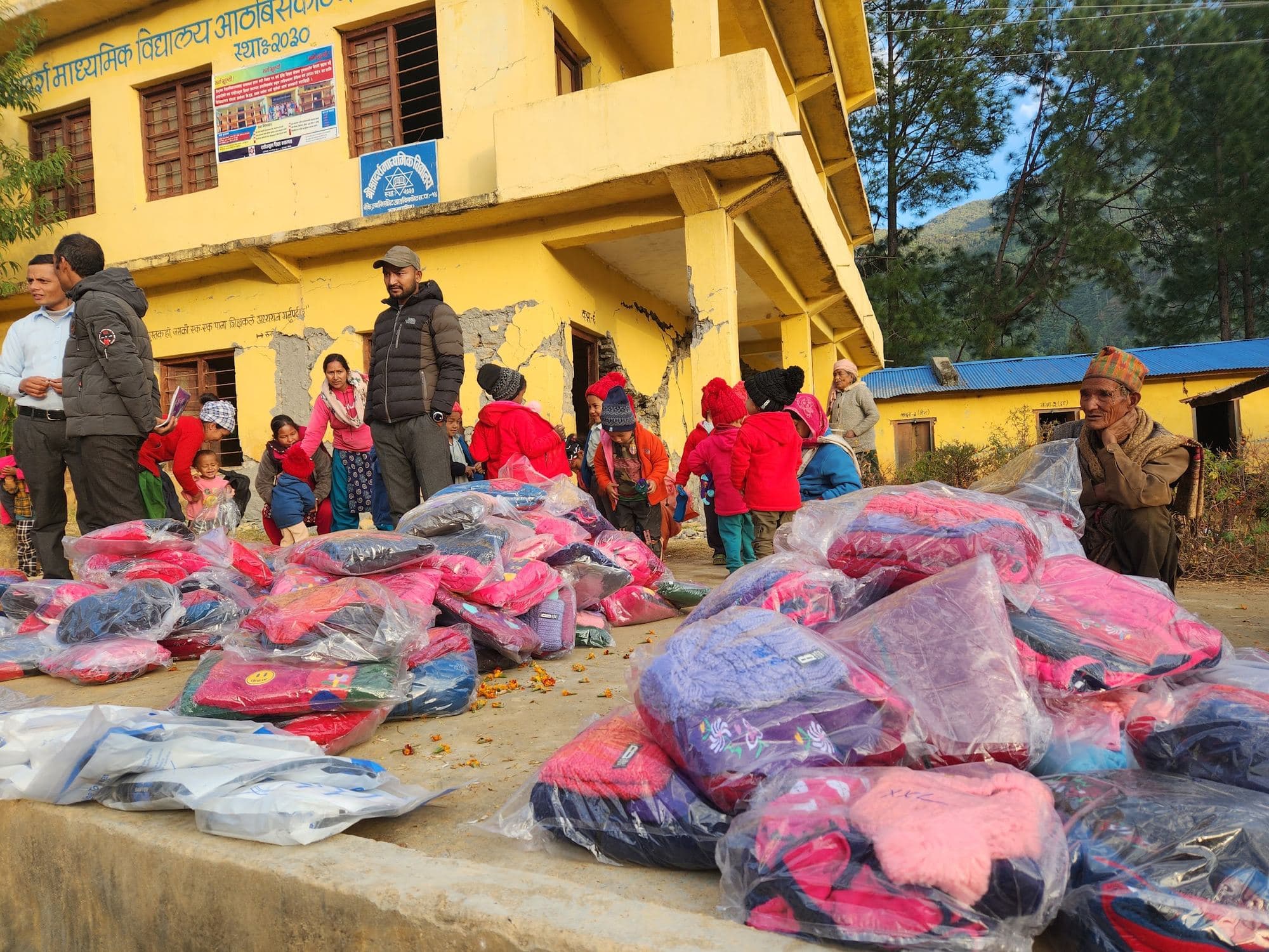 Bags of warm clothes laid out and ready outside the school in Jajarkot, December 2023