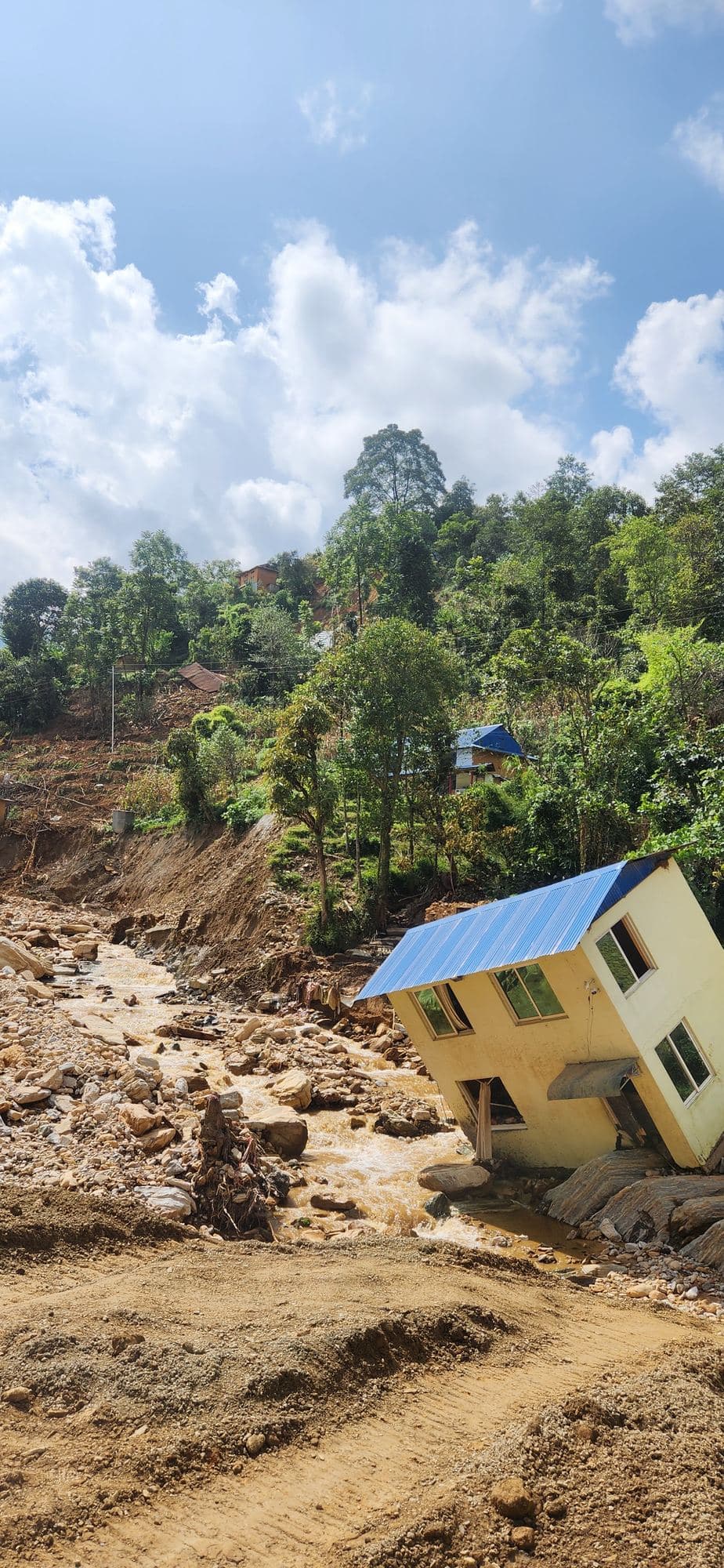 A house left standing at the edge of a landslide