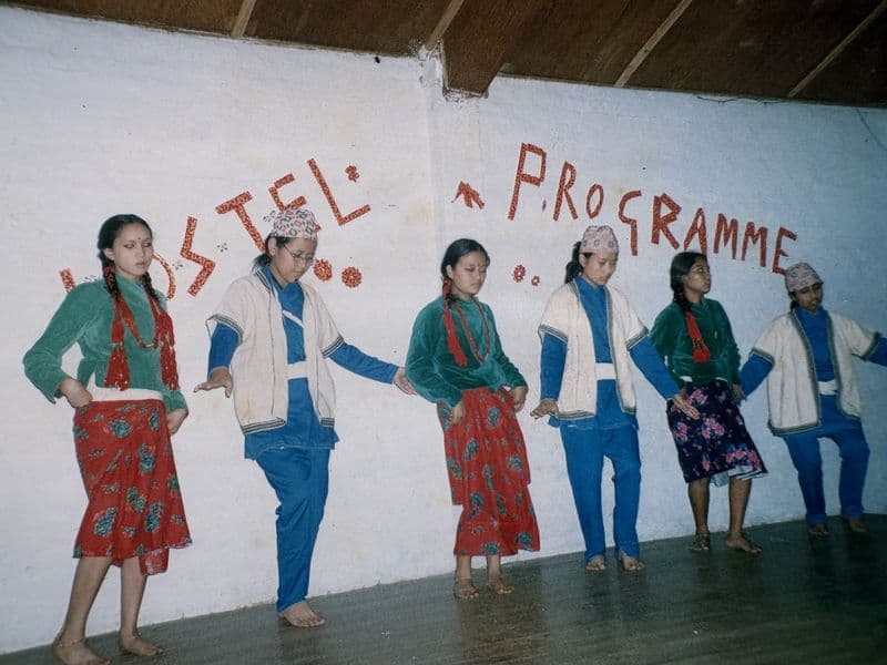 Pooja and other girls in traditional dress, dancing at a Bal Mandir hostel programme
