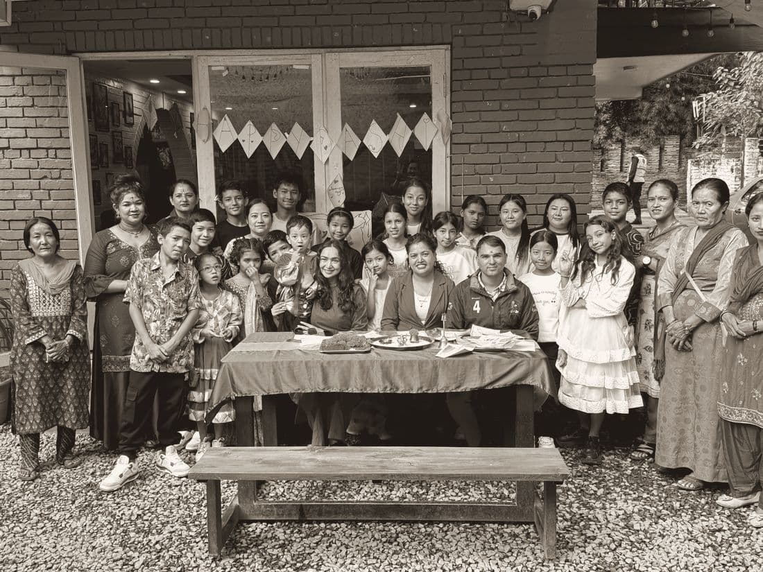 A large group of children and families outside a school