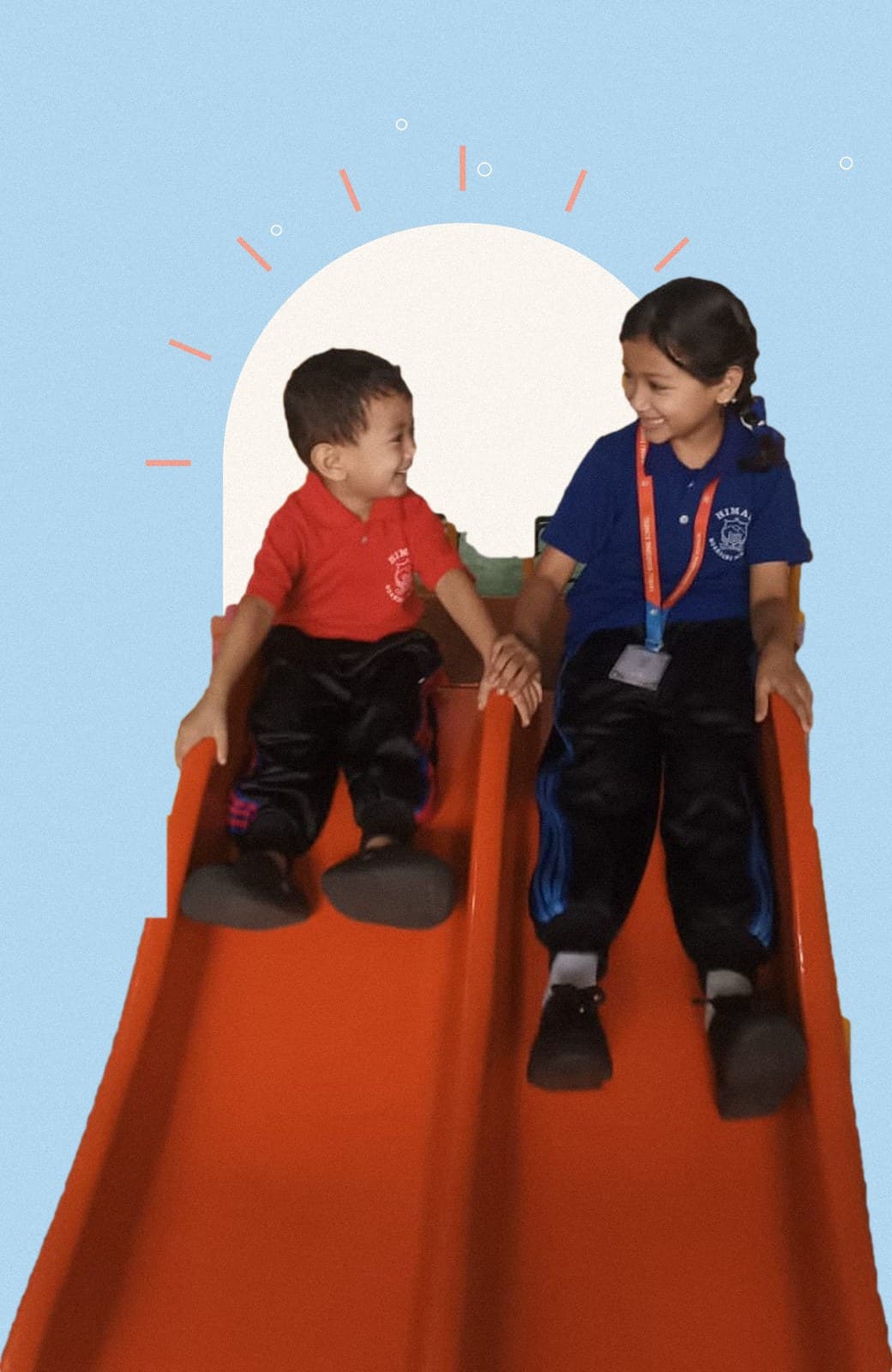 Aditi and Advik side by side on a slide, holding hands