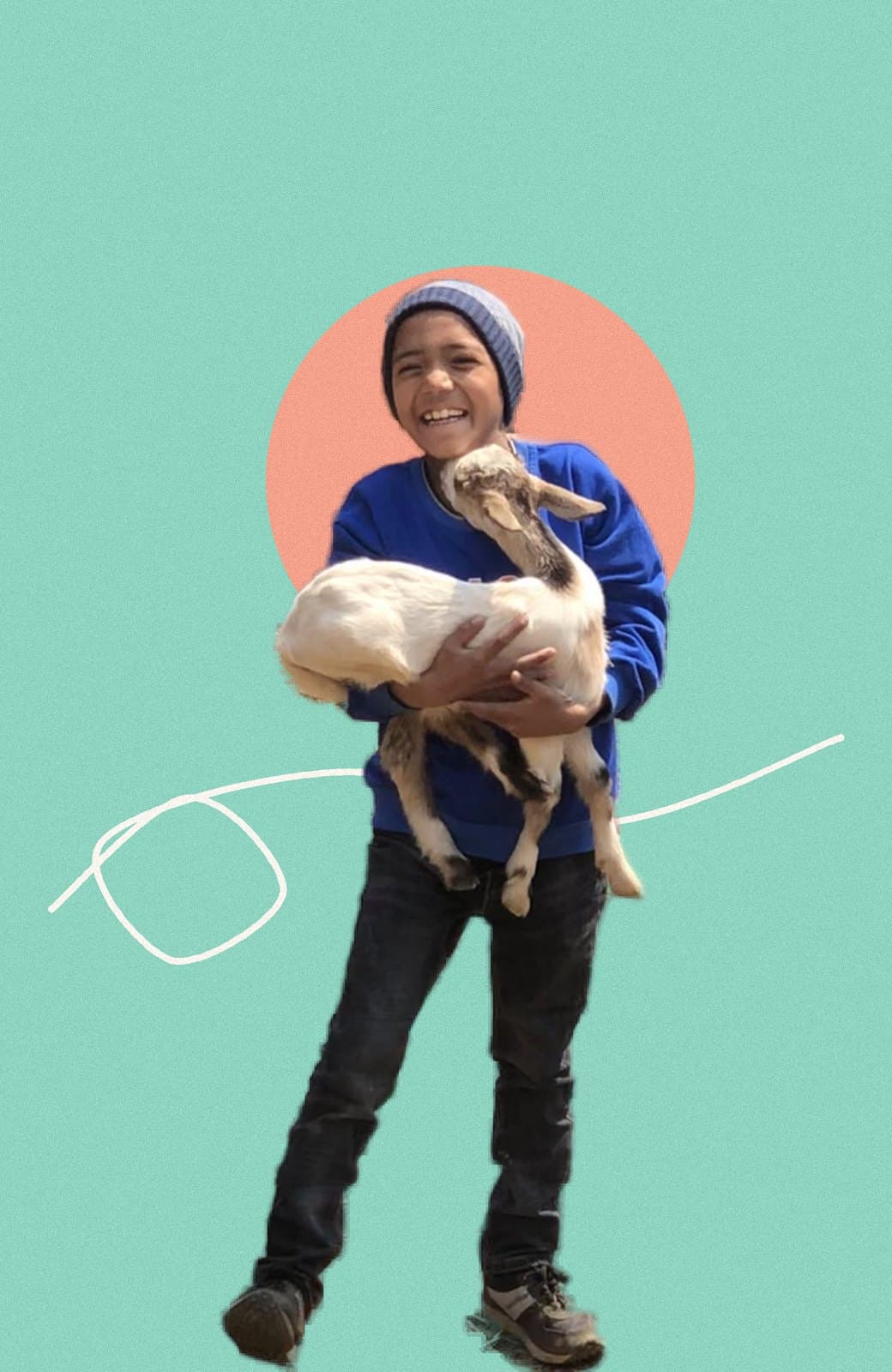 Khumba laughing, holding a young goat