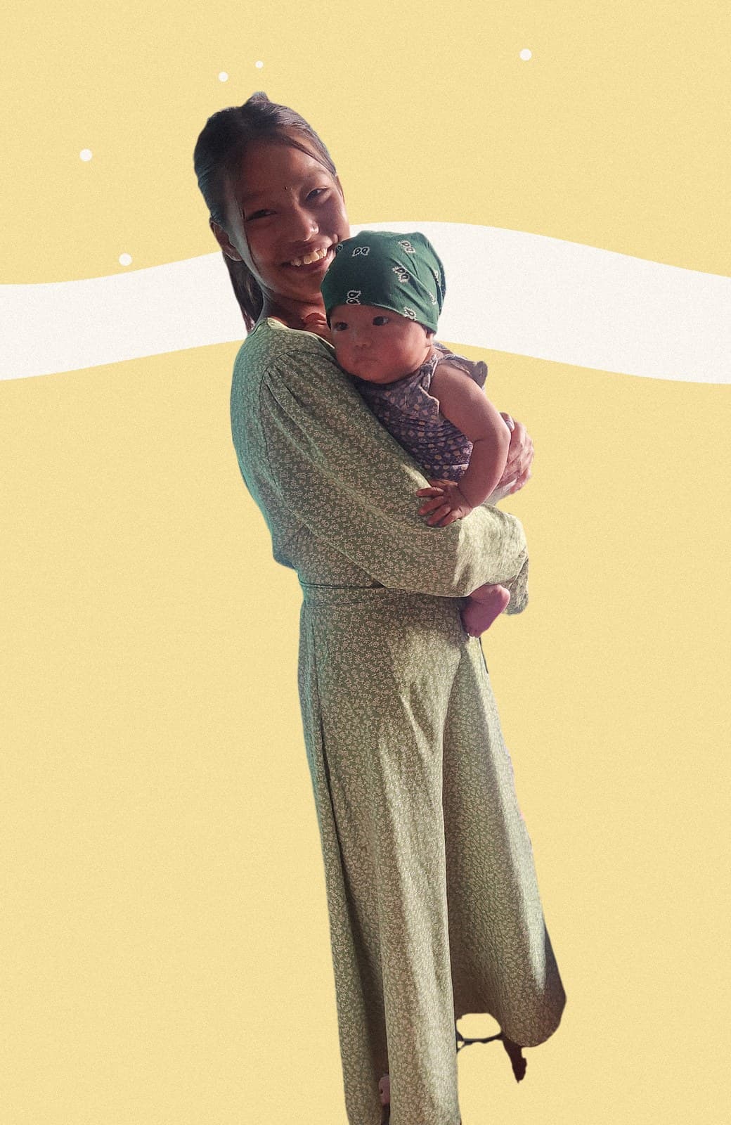 Sushmita smiling, holding her baby